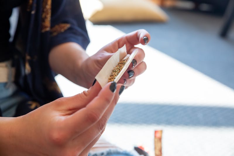 Person rolling a cannabis joint